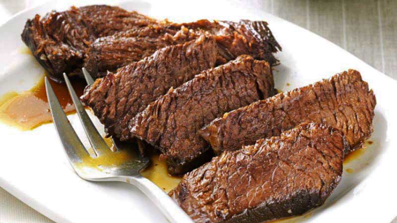 tiras de solomillo de carne con salsa y un tenedor debajo