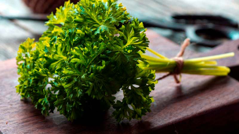 tabla de madera con unas hierbas atadas